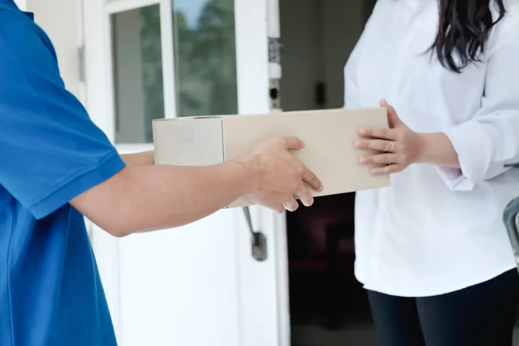 person receiving package at the front door utc